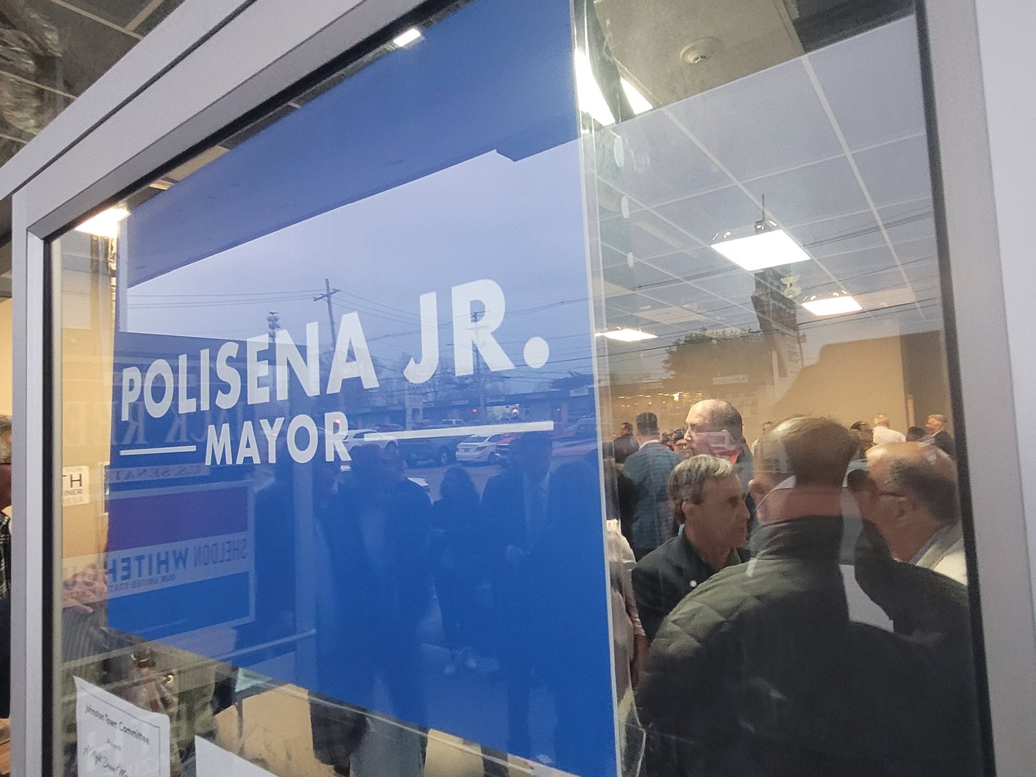 BIG CROWD: Johnston Mayor Joseph M. Polisena introduced his son to an overflow crowd in an empty storefront in Town Hall Plaza. Joe Polisena Jr. announced his candidacy for mayor, in front of friends, family, local politicians and key community representatives.